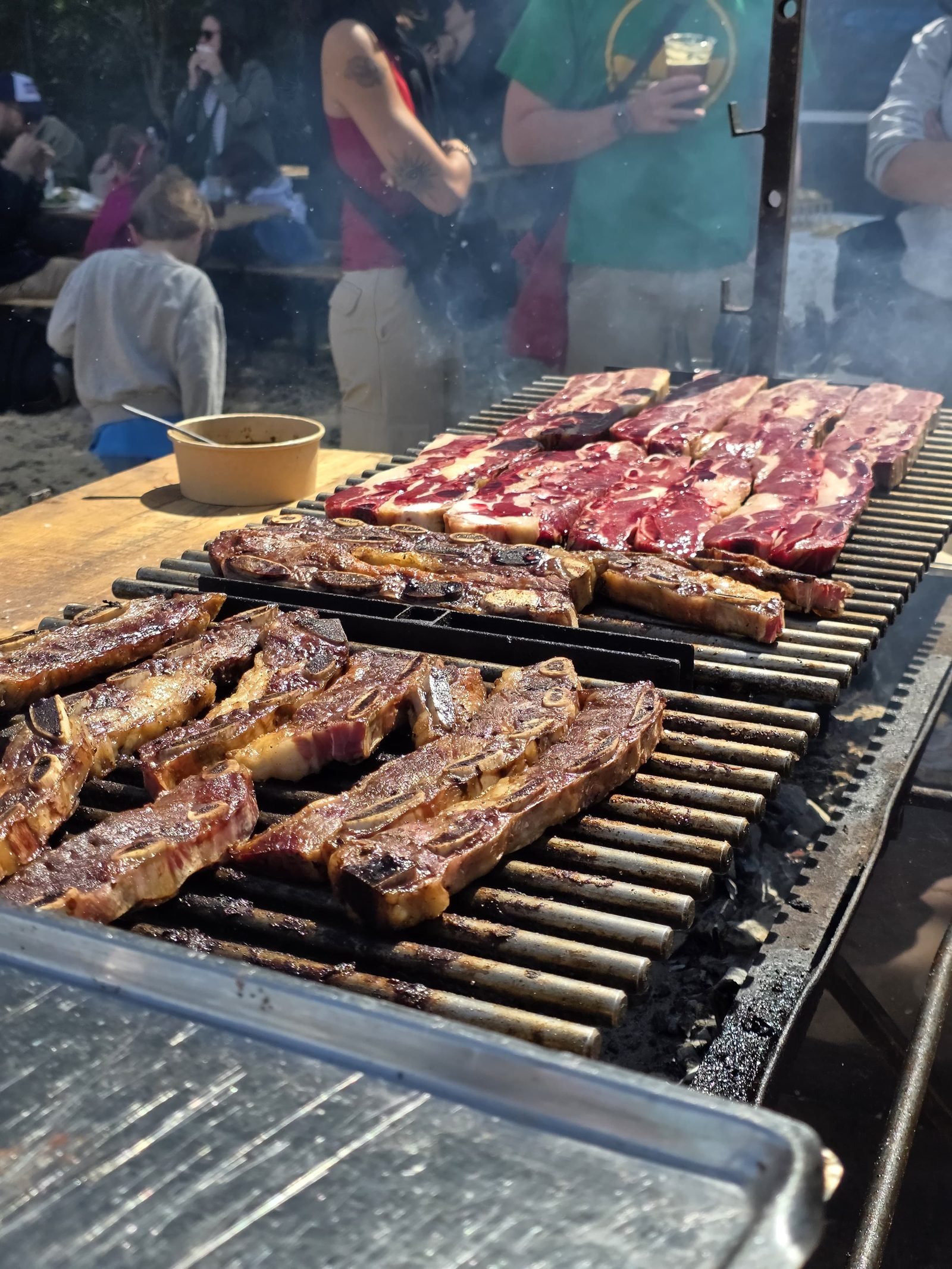 Argentine grill loaded with cuts of meat during a Gauchas asado in Copenhagen